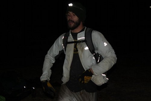 larry Men with beard wearing a bag from front side view.