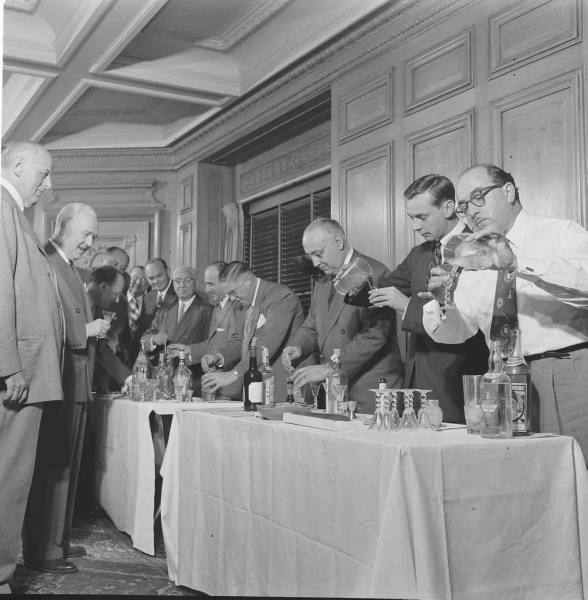 A group of men making the perfect martini.