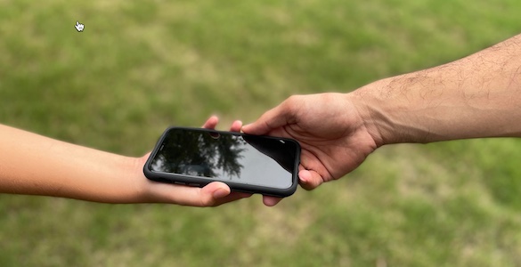 A tech thinker holding a smartphone.